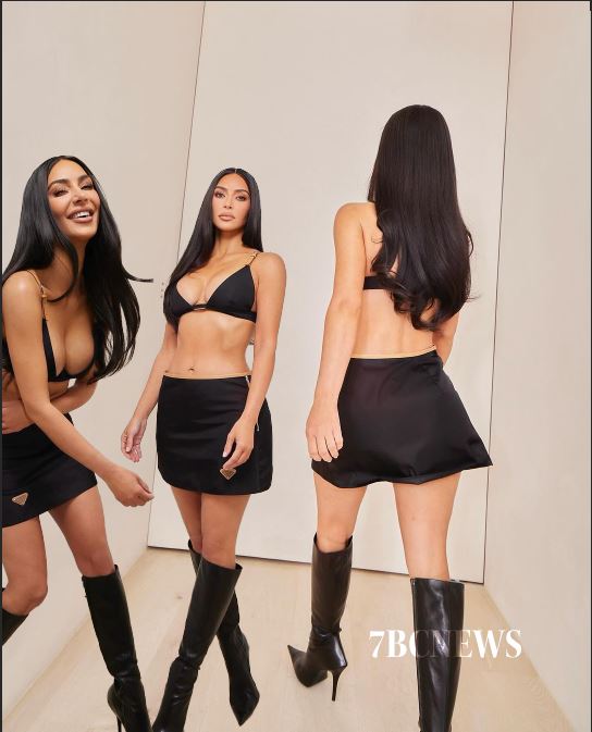 A picture of Kim Kardashian wearing a low-cut bikini top and a matching Prada mini skirt.